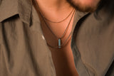 man wearing silver chains