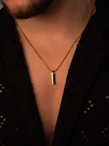 gold pendant chain on black shirt